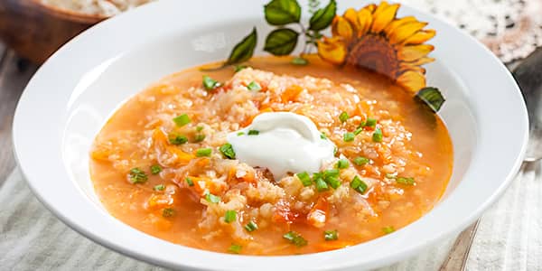 Classic cabbage soup with millet and sour cream